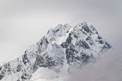 Scenic view of snowcapped mountains against clear sky