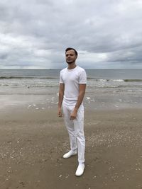 Full length of young man standing on beach