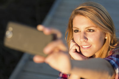 Close-up of young woman using smart phone