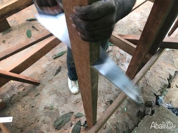 Low section of man working on table