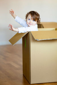Cute girl with blue eyes in cardboard box