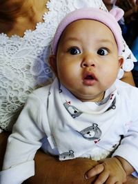 Close-up of cute baby girl at home