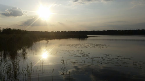 Scenic view of calm lake at sunset