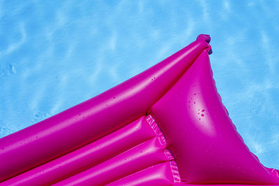 High angle view of pink inflatable raft in swimming pool