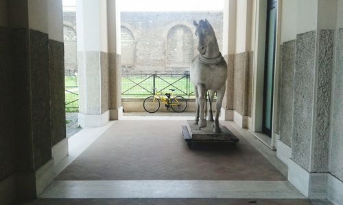 Horse statue by door at historic building