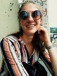Portrait of smiling young woman wearing sunglasses