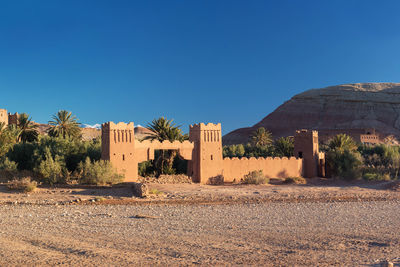 Scenic view of desert against clear blue sky