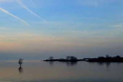 Scenic view of sea against sky at sunset