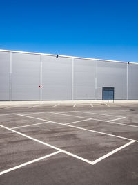 Empty parking in front of an aluminium cladding modern building