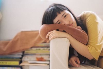 Portrait of young woman relaxing on bed at home