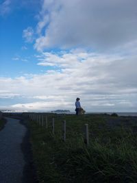 Man standing on beach against sky