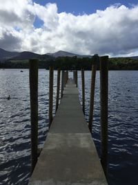 Pier over lake against sky