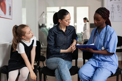 Mother and daughter talking with doctor