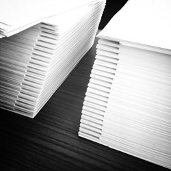Close-up of cropped white papers on table