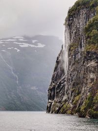 Scenic view of sea and mountains against sky