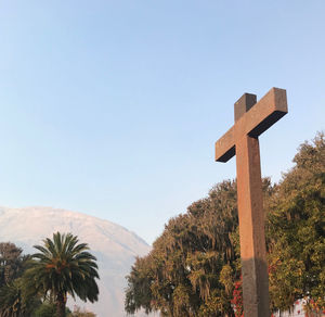 Cross against clear blue sky