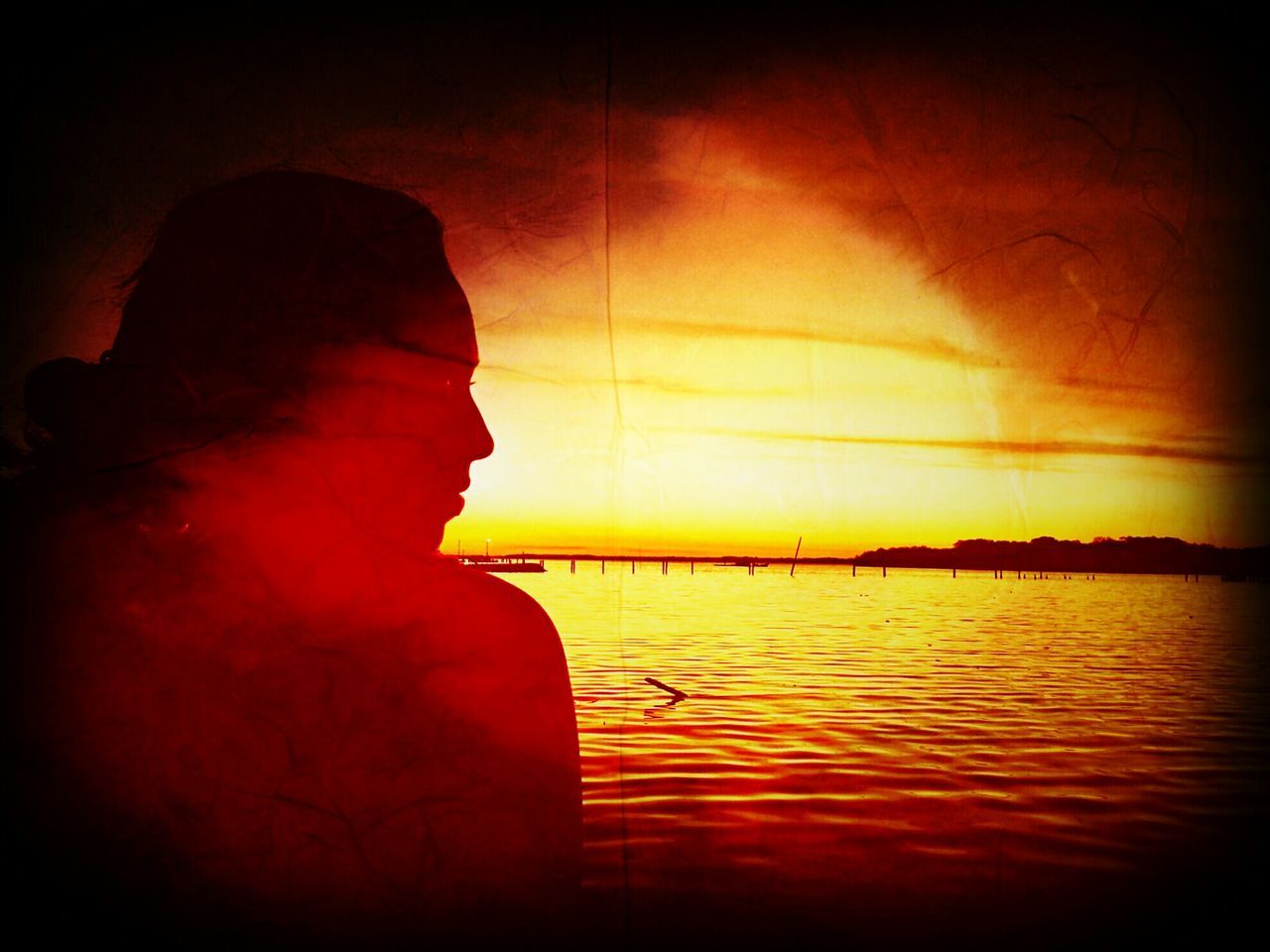 sunset, water, orange color, reflection, silhouette, sky, beauty in nature, scenics, tranquility, tranquil scene, waterfront, sea, nature, idyllic, one person, dusk, sun, lake, horizon over water, red