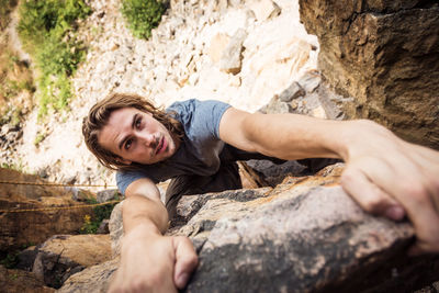 Portrait of young man on rock