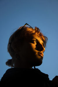 Side view of young man against clear sky