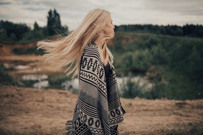 Midsection of woman standing on field