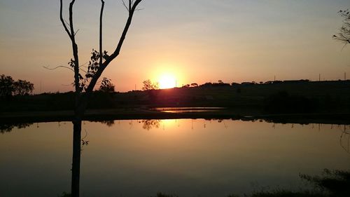 Scenic view of lake at sunset