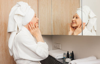 Portrait of female doctor examining patient at clinic