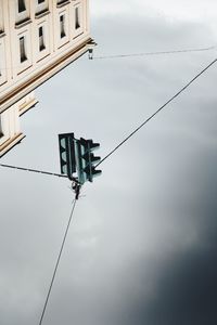 Low angle view of telephone pole against sky