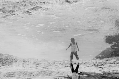 Full length of woman standing on beach during winter