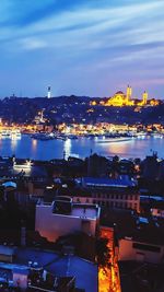 High angle view of illuminated harbor in city at night