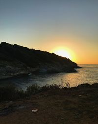 Scenic view of sea against clear sky during sunset