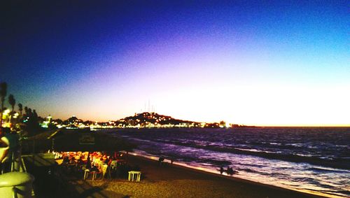 Scenic view of beach against blue sky