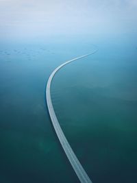 High angle view of airplane flying over swimming pool