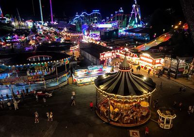 High angle view of illuminated carousel at night