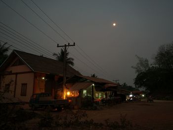 Houses against sky at night