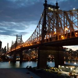 Illuminated suspension bridge over river