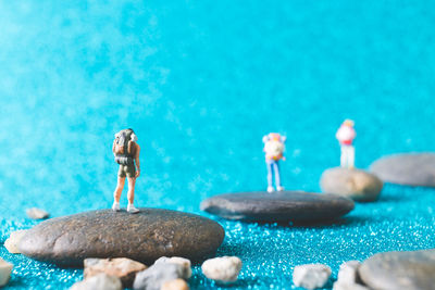 Woman standing on rocks by swimming pool