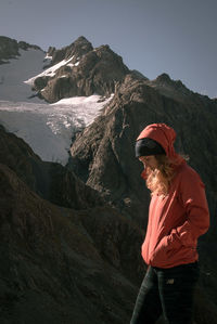 Woman standing against mountains