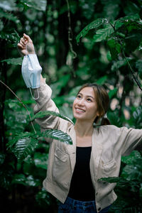 Portrait of a smiling young woman standing outdoors
