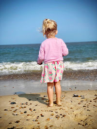 Rear view of girl standing on beach