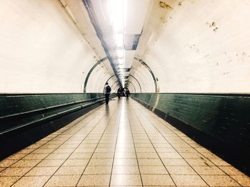 Man walking in illuminated subway
