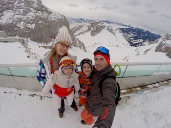 Women standing on snow covered mountain during winter