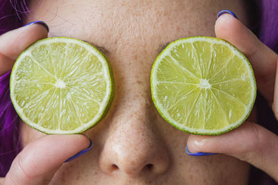 Cropped image of woman holding fruit