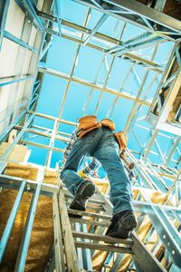 Low angle view of man working on construction site