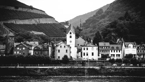 Buildings by river at rudesheim am rhein