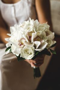 Midsection of woman holding flower bouquet