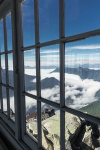 Scenic view of snowcapped mountains seen through window