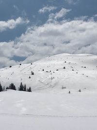 Scenic view of snow covered mountains against sky