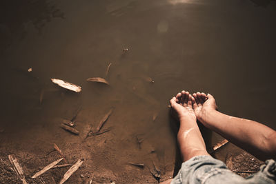 Low section of man relaxing on shore