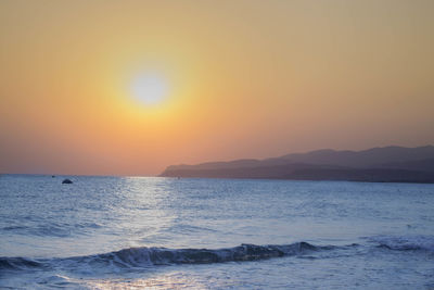 Scenic view of sea against clear sky during sunset