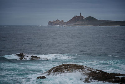 Cabo vilan ligthouse in the atlantic ocean seen from muxia in galicia, spain